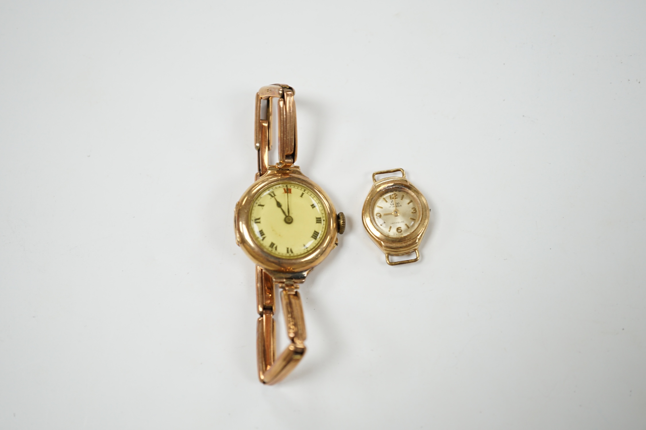 A lady's early 20th century 9ct gold manual wind wrist watch, on a 9ct expanding bracelet, gross weight 19.4 grams, together with a lady's 9ct gold Elco watch. Condition - poor